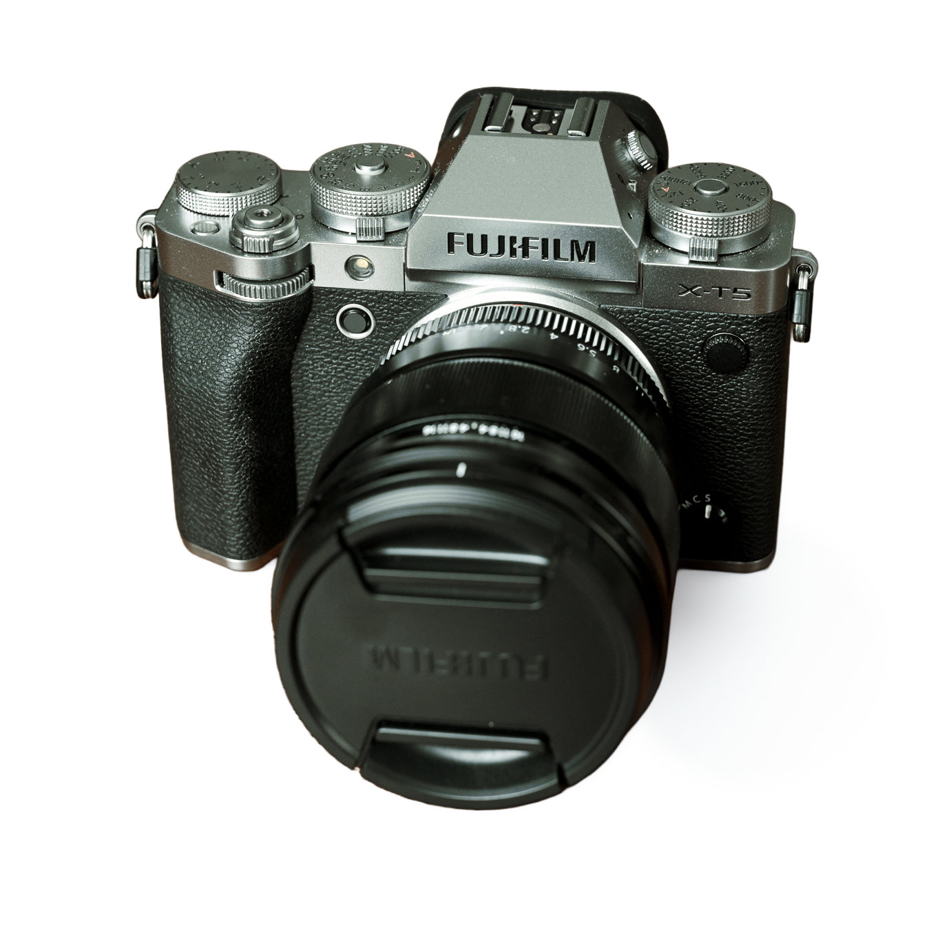 Fujifilm camera with lens cap on a white background
